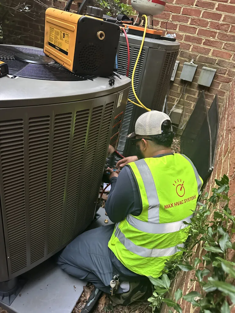 Max HVAC Systems technician servicing air conditioning unit in Springfield, VA.